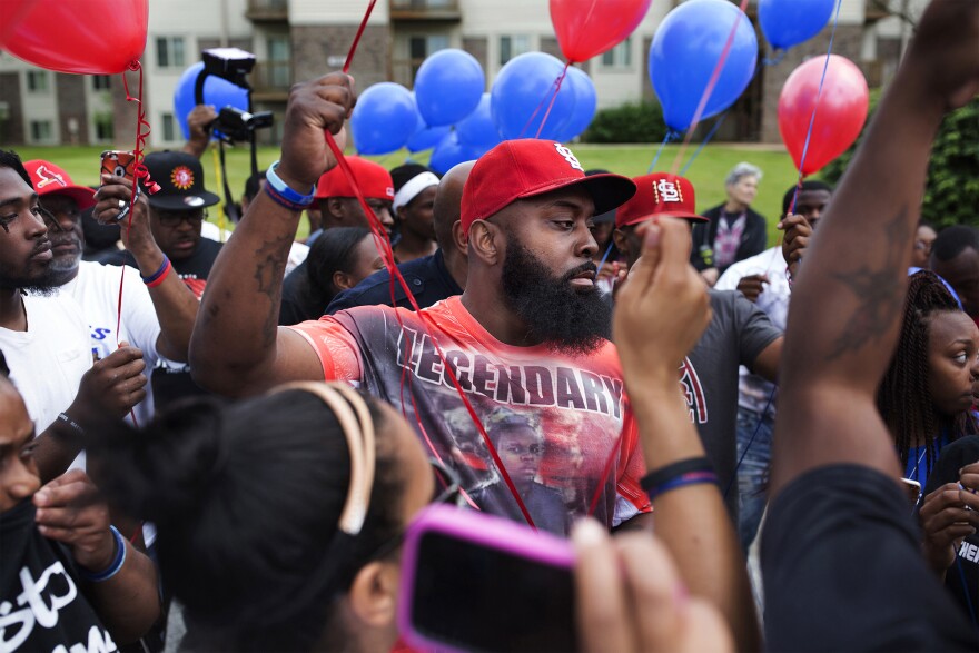 Michael Brown Sr. gets ready to release balloons to honor what would have been his son's 20th birthday at a party to honor Mike Brown's life at Canfield Green Apartments in Ferguson, Mo., on May 20, 2016.