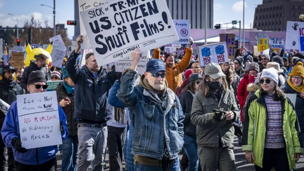 Protesters walk down Lomas Boulevard in Downtown Albuquerque on Sunday. Many protestors chanted and held signs against Immigration and Customs Enforcement.