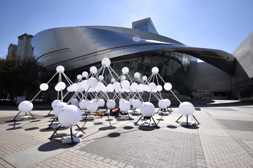 The "Affinity" sculpture sits in the plaza outside Charlotte's NASCAR Hall of Fame.