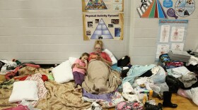 Christine Garcia relaxes with her 8-year-old daughter Mia in the Channelview High School gym. It's been turned into an evacuation shelter for victims of flooding from Harvey.
