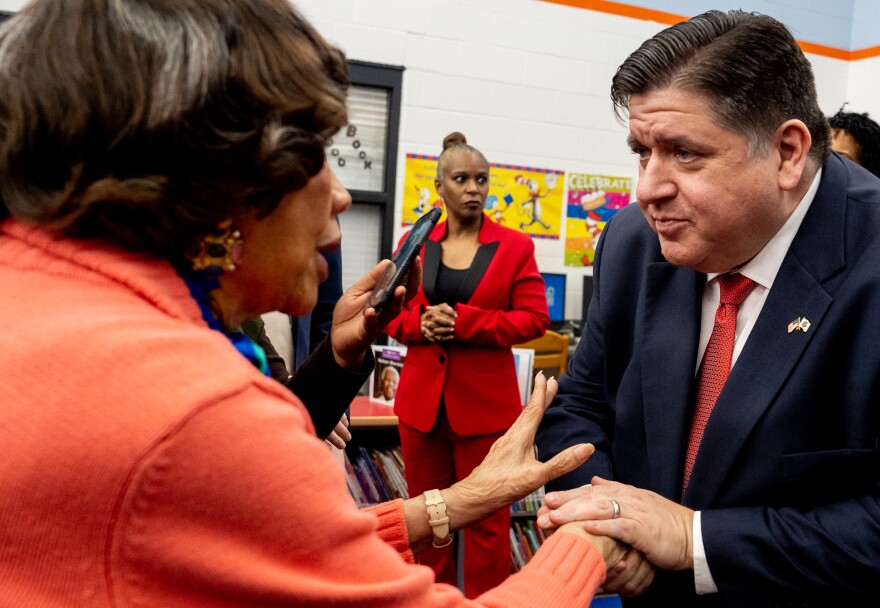 Illinois Gov. JB Pritzker shakes hands with Dr. Lillian A. Parks, the first woman superintendent in the East St. Louis School District on Thursday, Feb. 16, 2023, at the Vivian D. Adams Early Childhood Center in East St. Louis. Parks is the school namesake’s twin sister.