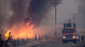 A makeshift fire truck puts water on a wildfire, which is part of the Okanogan Complex, as it burns through brush on Aug. 22, 2015 near Omak, Washington. (Stephen Brashear/Getty Images)