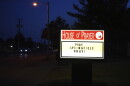 a lighted sign is pictured in the dark that says "pray springfield pray!"