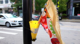 A flag sits at a crosswalk in Northside for pedestrians to use to attract a driver's attention that they want to cross the street.