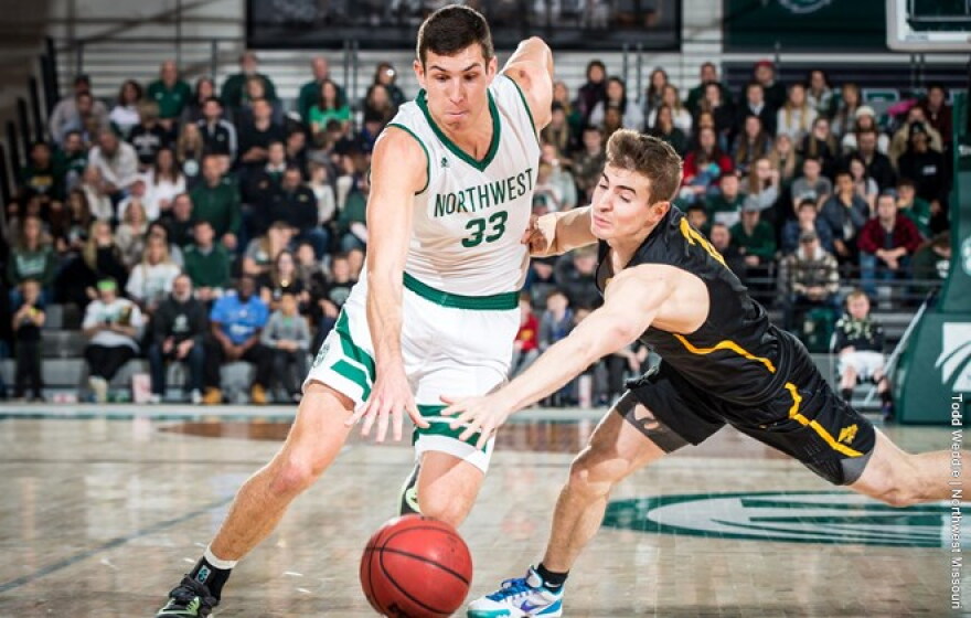 Action shot of Ryan Hawkins vs Newman basketball