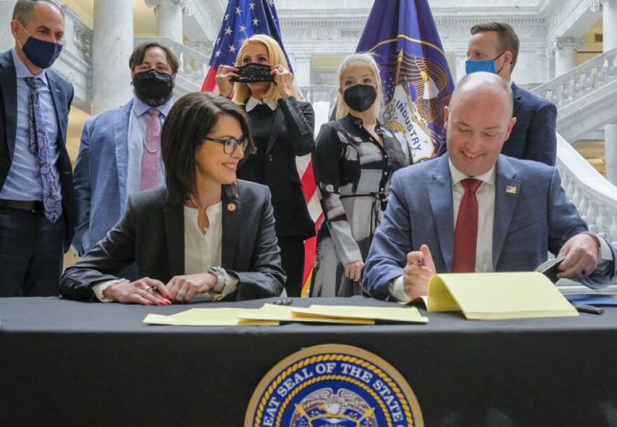 (Leah Hogsten | The Salt Lake Tribune) Utah Gov. Spencer Cox, right and Lt. Gov. Deidre Henderson, left, were joined by activists and supporters of SB127 in the Capitol rotunda, April 6, 2021 for the ceremonial bill signing that will bring more oversight to the state’s so-called troubled-teen industry. In back l-r Sen. Mike McKell, R-Spanish Fork, activist Jeff Netto, activist Paris Hilton, activist Caroline Lorson and Rep. Brady Brammer, R-Highland.