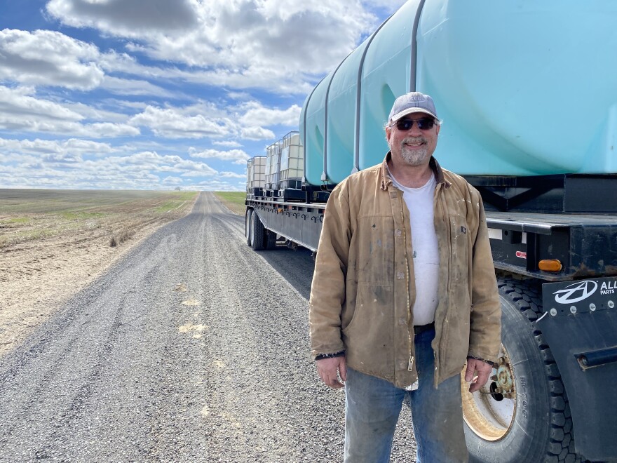 Wayde Hudlow is a dryland wheat farmer. He stands near the gravelly corner of Lone Star and Hoover that divides four wheat fields. He says input costs have been going up so fast it’s hard to farm.