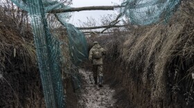 A Ukrainian soldier walks in a trench on the front line in Zolote, Ukraine, on Dec. 12. A build-up of Russian troops along the border with Ukraine has heightened worries that Russia intends to invade.