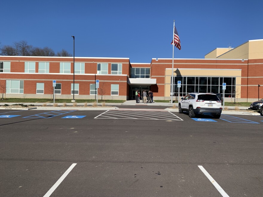 Parents and law enforcement gather in front of Tuscarawas Valley Middle-High School.