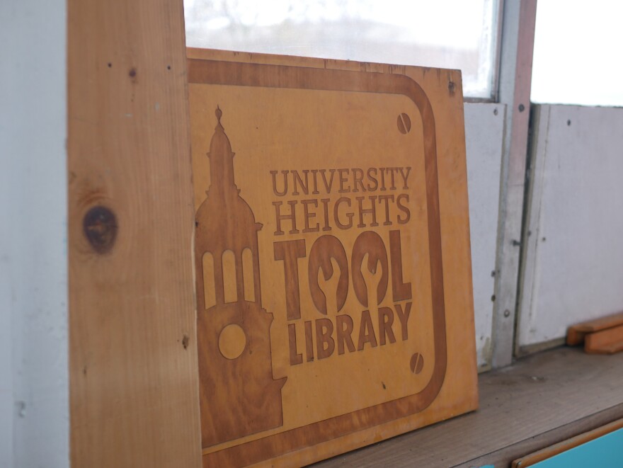 A piece of wood that has the engraving of "University Heights Tool Library".