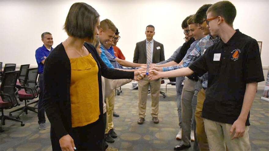 Youth apprentices with CareerWise Elkhart County participate in a team-building activity while Jason Harrison of Horizon Education Alliance supervises.