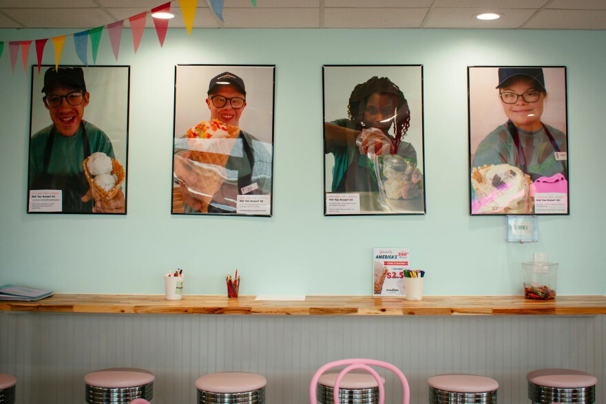 pictures of kids scooping ice cream on a wall in an ice cream shop