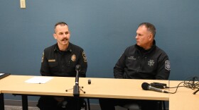 Eugene-Springfield Fire Chief Mike Caven (left) and Eugene Police Chief Chris Skinner (right) seated at a table.