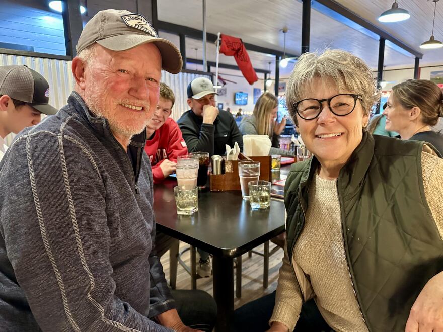 A smiling couple, Stan and Sandy Labertew, sit at a table at Fly Boy Brewery and Eats in Sylvan Grove Kansas