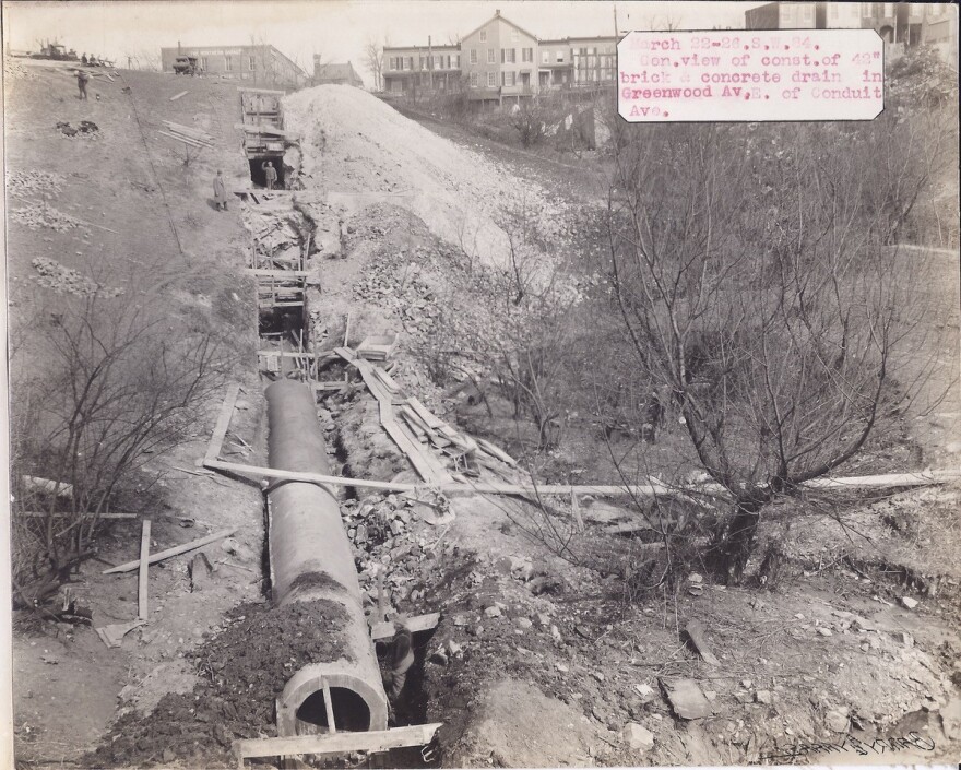 An archival photo showing engineers burying a small stream in Baltimore's Hampden neighborhood (Photo credit: Baltimore DPW Archives and Ronald Parks)