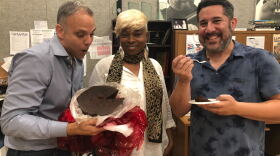 Meet our South Florida holiday food panel: Carlos Frias (left) and Kathy Ann Paul (middle). WLRN Sundial host Luis Hernandez is trying Carribean Black Cake.  
