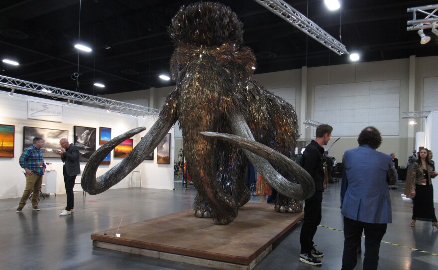 A large mammoth sculpture made out of metal