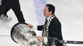 Carolina Hurricanes head coach Rod Brind'Amour, right, lifts the Stanley Cup after a win over the Vegas Golden Knights in Game 6 of the NHL hockey Stanley Cup Final series, Sunday, June 14, 2026, in Las Vegas.