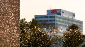 3M headquarters building with trees and water spray in the foreground