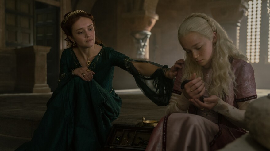 Helaena (Evie Allen) says creepy things while holding creepy things as the queen (Olivia Cooke) looks on.