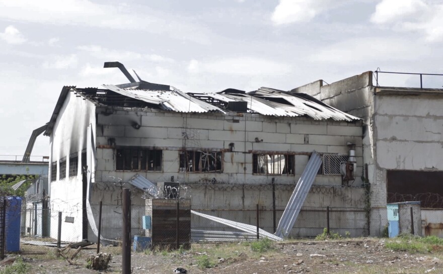 In this photo taken from video, a view of a destroyed barrack at a prison in Olenivka, in an area controlled by Russian-backed separatist forces in eastern Ukraine on Friday.
