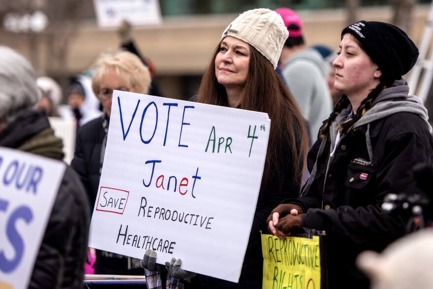 Melissa Johnson holds a sign in support of Wisconsin state supreme court candidate Judge Janet Protasiewicz during a rally Saturday, March 11, 2023, in Appleton, Wis.