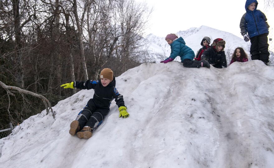 Students at Moose Pass School play in the snow on the school’s playground.