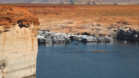 Boats sit in the low waters of Lake Powell near Page, Arizona on May 14, 2026. Climate change and drought have shrunk the Colorado River's supplies, and negotiators have struggled to rein in demand. As a result, its largest reservoirs have dropped to record low levels.
