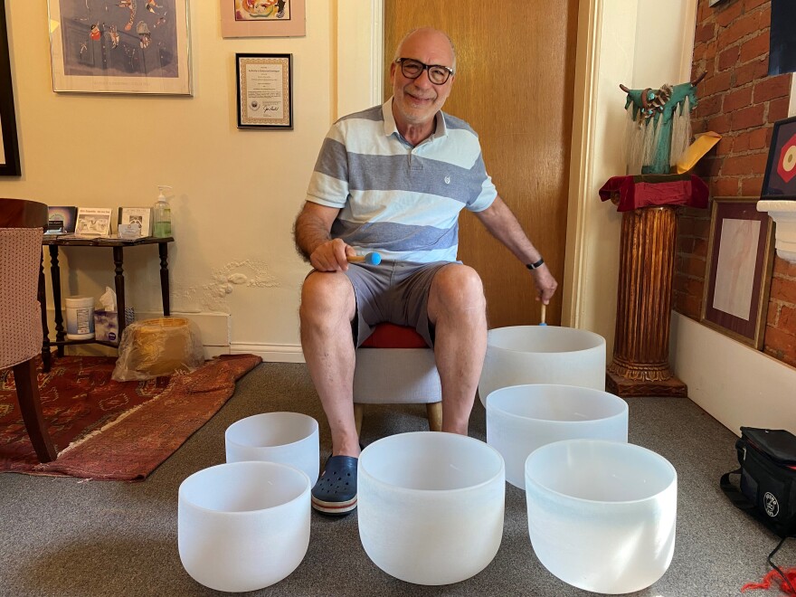 Ron Esposito set up the crystal and Tibetan singing bowls in his office to demonstrate. what they sound like. This soothing music is night and day from the blues he used to play.