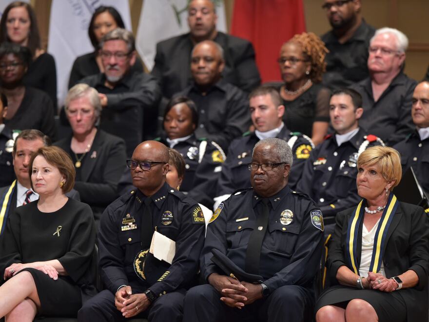Dallas Police Chief David Brown (second from left) and Dallas Area Rapid Transit Police Chief James Spiller (second from right) attend an interfaith memorial service for the victims of the Dallas police shooting.