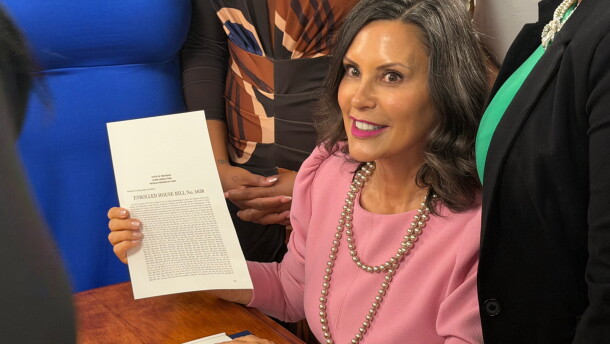 Governor Gretchen Whitmer signed the new Michigan school aid budget Tuesday surrounded by teachers, students, and legislators at a school in Southfield