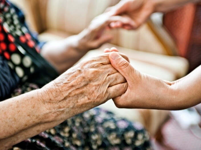 Two people hold hands.