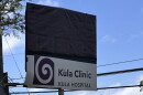 A Kula Hospital sign is covered with a tarp, while the facility's small Kula Clinic remains open.