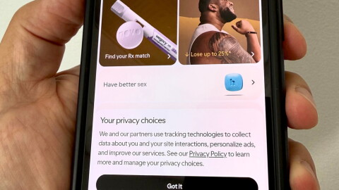 smartphone shows a website on a screen that depicts ads with a disclaimer headlined "Your Privacy Choices"