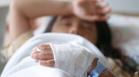 child or kid patients or sick and headache with feverish on head in pediatric hospital with salt water saline on hand for treatment healthcare and sleep rest on bed in hospital from infusion a disease