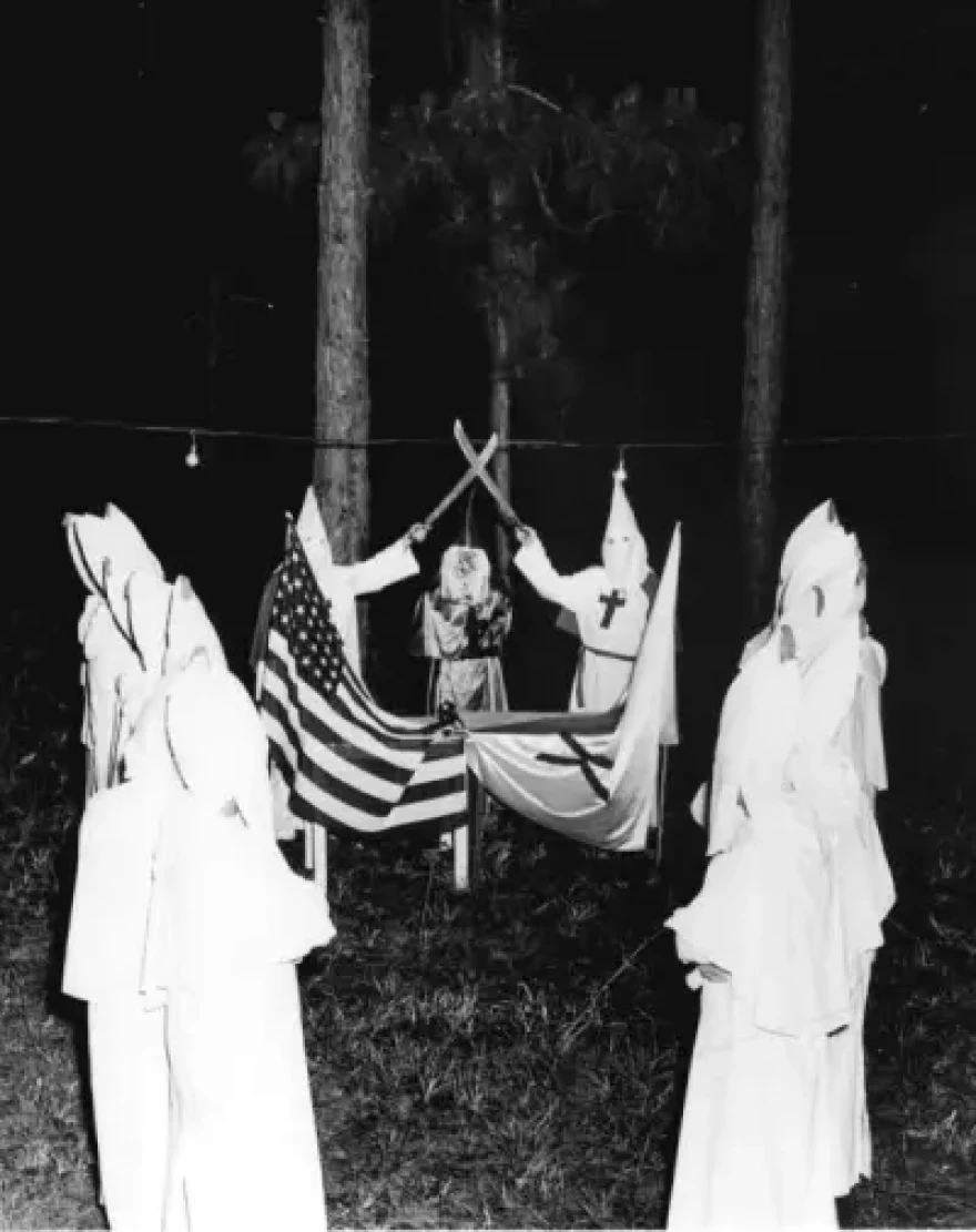 Florida KKK members performing a ceremony at a rally. Photographed on June 12, 1949.