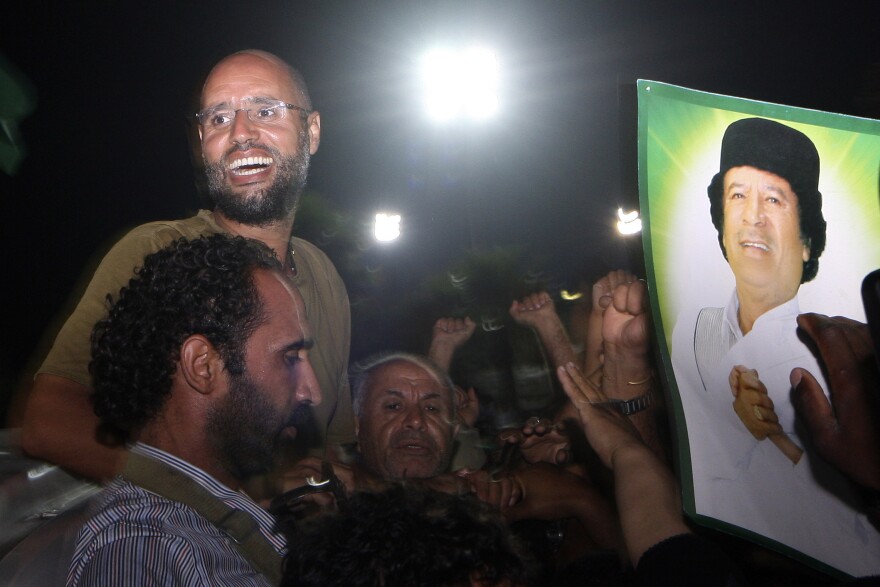 Saif Al-Islam Gadhafi greets troops loyal to his father, Moammar Gadhafi, in Tripoli, Libya, on Aug. 23, 2011.