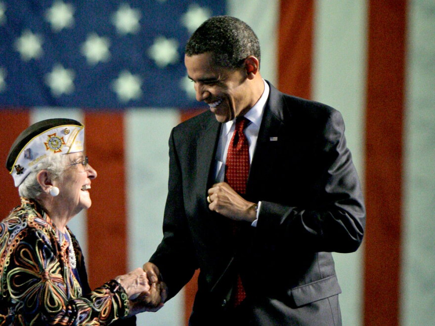 President Obama is greeted prior to speaking at the Veterans of Foreign Wars National Convention in Phoenix Monday.