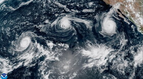 A satellite image shows from left to right, Hurricane Lowell, Hurricane Karina and Hurricane Marie in the Pacific on Saturday.