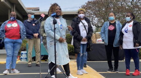 About 200 people gathered for a candlelight vigil Saturday evening to remember those who died in Thursday's mass shooting at a FedEx facility.
