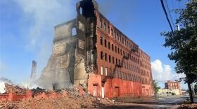 The historic Tent City building complex at Lyell and Dewey avenues was being demolished on Friday, Aug.1, 2025, after being destroyed by fire overnight. The building caught fire late Thursday, and by morning the city determined the entire six-building complex was structurally compromised an needed to be torn down.