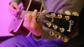 An acoustic Gibson guitar.