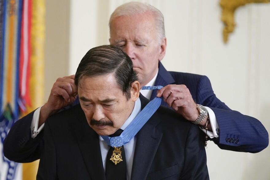 President Joe Biden awards the Medal of Honor to Spc. Dennis Fujii for his actions on Feb. 18-22 1971, during the Vietnam War, during a ceremony in the East Room of the White House, Tuesday, July 5, 2022, in Washington. (AP Photo/Evan Vucci)