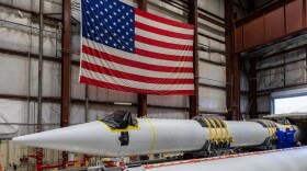 A rocket booster being prepared to be sent to Florida in a warehouse.