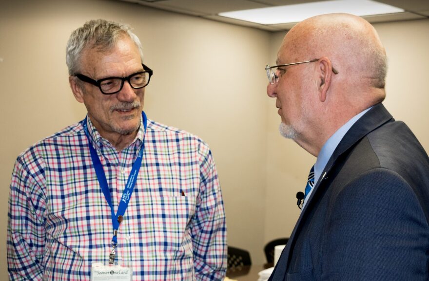 CDC director Redfield speaks with HIV/AIDS patient advocate Dennis Creedon, left, during the tour.