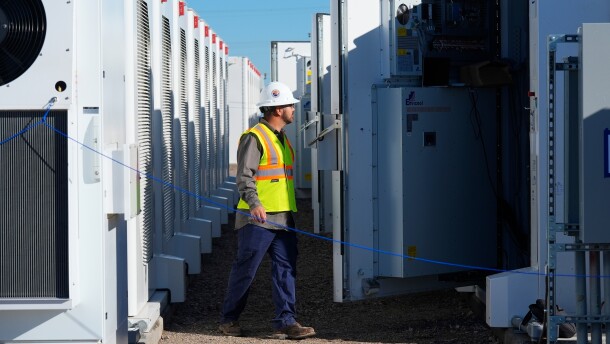 A worker does checks on battery storage pods at Orsted's Eleven Mile Solar Center lithium-ion battery storage energy facility Feb. 29, 2024, in Coolidge, Ariz. 