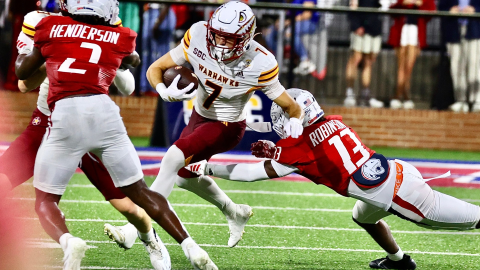 Picture of ULM receiver breaking an arm tackle from a Jaguar defender.