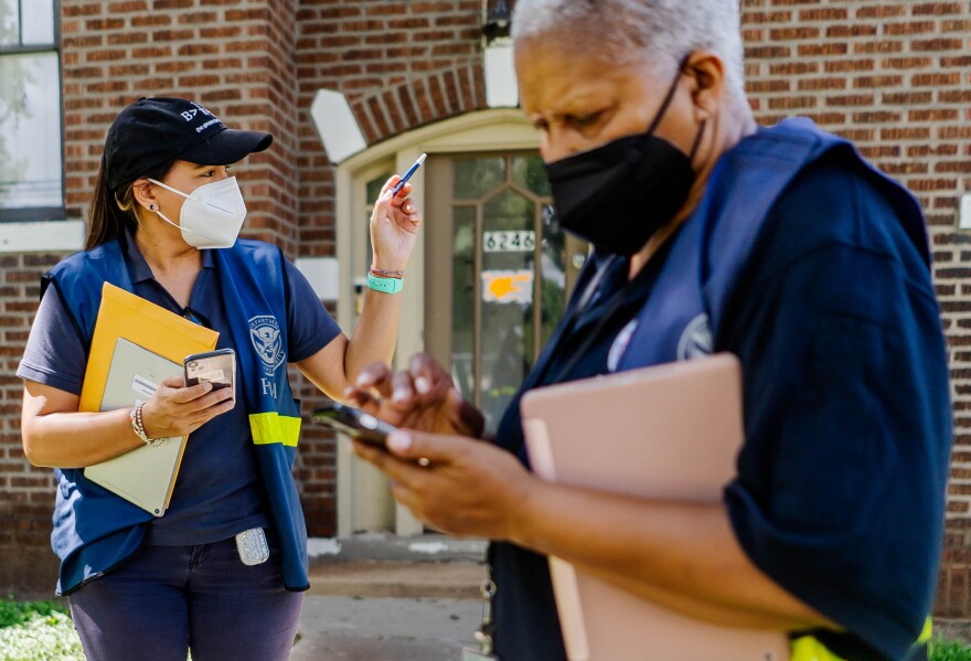 FEMA workers Wilmary Medina and Elaine Braswell canvass along Cabanne Avenue and North Drive on Wednesday in University City. 