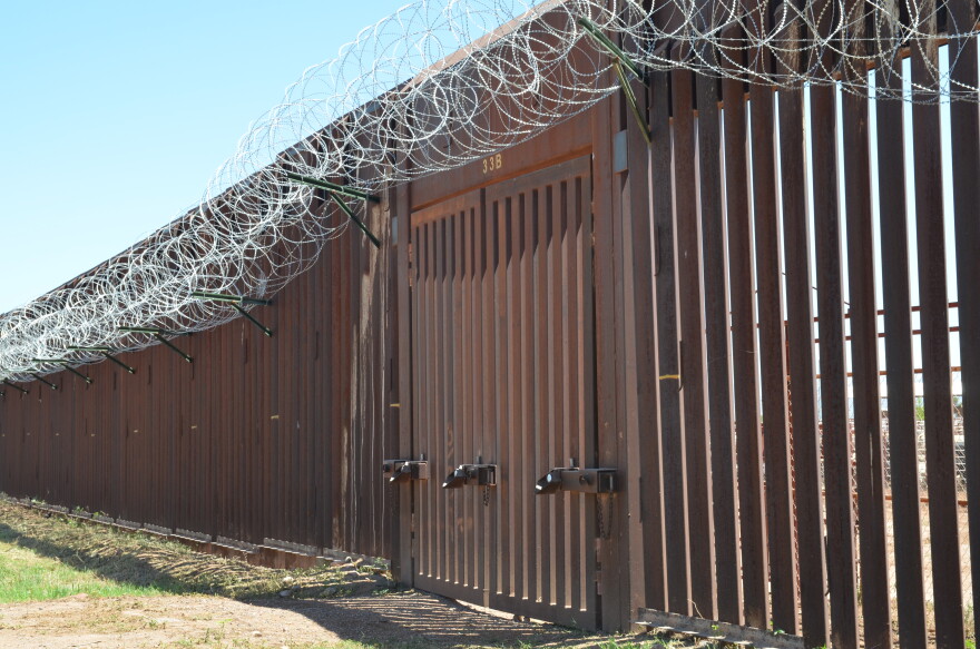 Closed door in metal border fence
