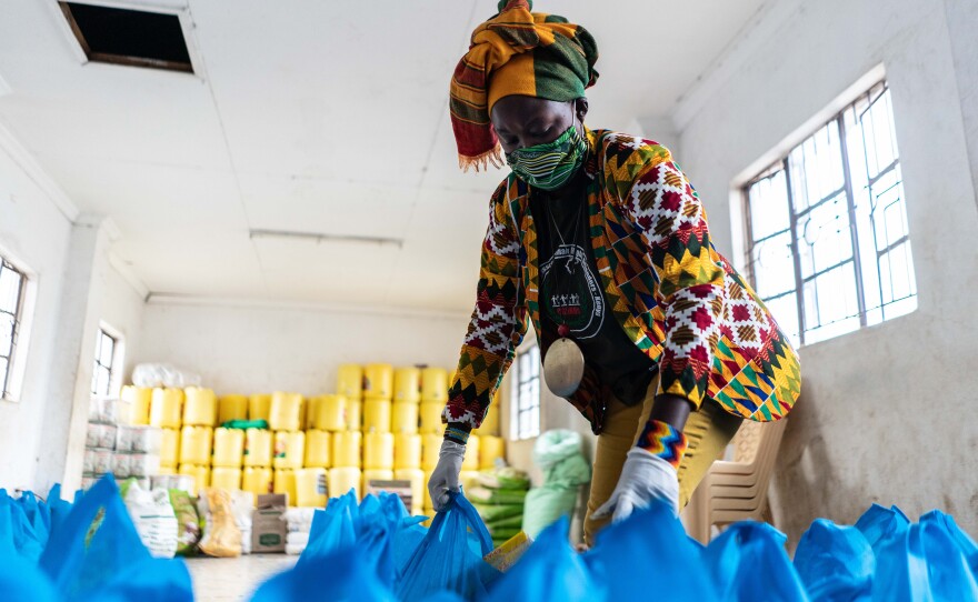 Rachael Mwikali from the Coalition for Grassroots Human Rights Defenders Kenya prepares bags of food aid in April 2020. The group is distributing them to families in Nairobi who have lost their income due to COVID-19.